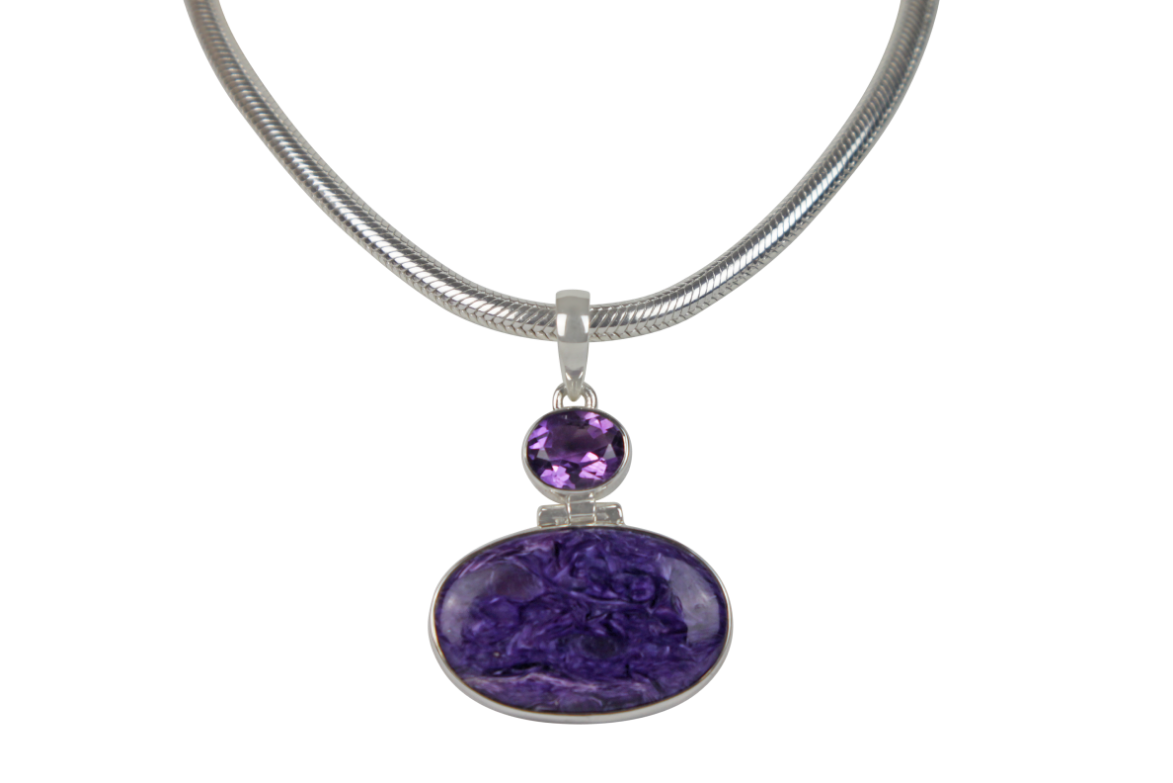 Very beautiful purple colour Oval cut Chorite pendant sitting horizontally with a very beautiful faceted Amethyst