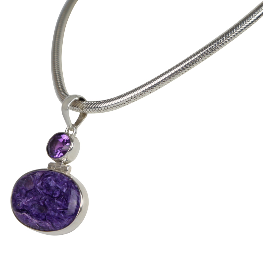 Very beautiful purple colour Oval cut Chorite pendant sitting horizontally with a very beautiful faceted Amethyst