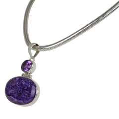 Very beautiful purple colour Oval cut Chorite pendant sitting horizontally with a very beautiful faceted Amethyst